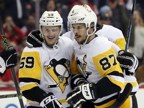 Jake Guentzel (59) of the Pittsburgh Penguins celebrates his game-winning goal against the Washington Capitals with Sidney Crosby at the Capital One Arena on April 26, 2018 in Washington, DC. (Bruce Bennett/Getty Images)