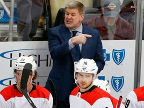 In this Jan. 23, 2018, file photo, Carolina Hurricanes head coach Bill Peters gives instructions during the first period of an NHL hockey game against the Pittsburgh Penguins