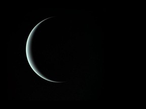 This image of a crescent Uranus, taken by Voyager 2 on January 24, 1986, reveals its icy blue atmosphere. MUST CREDIT: NASA/JPL.