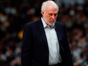 In this Feb. 23, 2018, file photo, San Antonio Spurs head coach Gregg Popovich looks down in the second half of an NBA basketball game against the Denver Nuggets