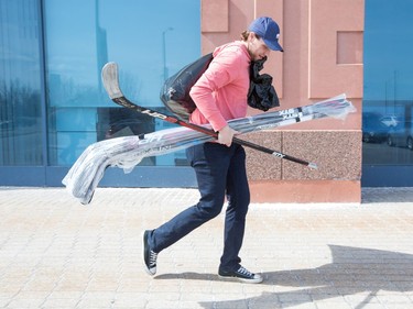 Bobby Ryan lugs his sticks to the car after the Ottawa Senators clear out their lockers and have their exit meetings with coaches and management at Canadian Tire Centre following the final game of the season on Saturday. Photo by Wayne Cuddington/ Postmedia