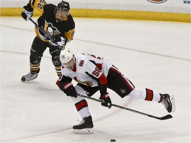 Senators forward Magnus Paajarvi controls the puck in front of Penguins forward Carl Hagelin during the first period of Friday's game.