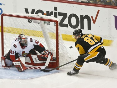 Senators goaltender Craig Anderson makes a save on Penguins star Sidney Crosby in the first period. The goal wouldn't have counted anyway because of a penalty to another Penguins player on the play.