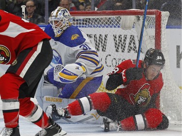 Buffalo Sabres goalie Chad Johnson (31) looks for the puck as Ottawa Senators forward Mike Hoffman (68) collides with the goal during the second period of an NHL hockey game Wednesday, April 4, 2018, in Buffalo, N.Y.