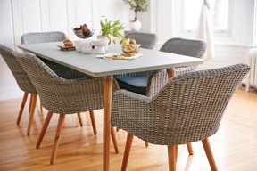 Bringing some of your outdoor furniture inside and pairing a light table with driftwood-coloured rattan chairs can help create a springlike feeling.