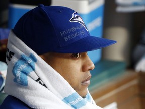 Toronto Blue Jays starting pitcher Marcus Stroman watches from the dugout during the first inning of a baseball game against the Texas Rangers, Saturday, April 7, 2018, in Arlington, Texas. Stroman had the name of Humboldt Broncos junior hockey team written on his cap in memory of those killed in their bus crash. (AP Photo/Michael Ainsworth)