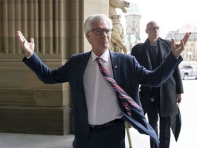 Minister of Natural Resources Jim Carr gestures in response to a reporter's question as he arrives on Parliament Hill ahead of a meeting between Prime Minister Justin Trudeau, B.C. Premier John Horgan, and Alberta Premier Rachel Notley on the deadlock over Kinder Morgan's Trans Mountain pipeline expansion, in Ottawa on Sunday, April 15, 2018.