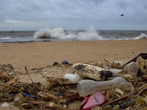 FILE- In this Aug. 13, 2015, file photo, a plastic bottle lies among other debris washed ashore on the Indian Ocean beach in Uswetakeiyawa, north of Colombo, Sri Lanka. Secretary-General Antonio Guterres  on Monday, June 5, 2017, opened the first-ever U.N. conference on oceans with a warning that the lifeblood of the planet is "under threat as never before," with one recent study warning that discarded plastic garbage could outweigh fish by 2050 if nothing is done. (AP Photo/Gemunu Amarasinghe, File) ORG XMIT: NYJK201