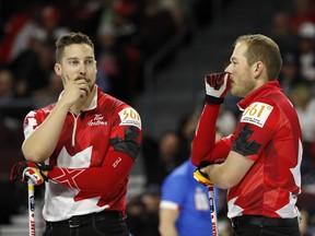 Canada's Brett Gallant, left, Geoff Walker seem to be looking for answers between ends of Friday morning's game against Sweden.