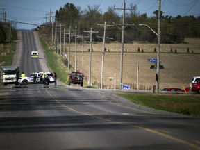 An ambulance leaves the scene of a collision at the intersection of Kinburn Side Road at John Shaw Road on Saturday, May 12, 2018.