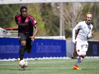 Ottawa Fury FC #3 Eddie Edward takes the ball down the field with Atlanta United 2 #30 Andrew Carleton during the game at TD Place Saturday May 12, 2018.