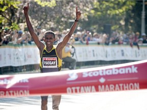 Yemane Tsegay crosses the finish line in first place for the marathon at Ottawa Race Weekend Sunday May 25, 2014.