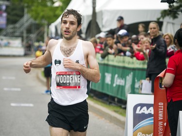 Tristan Woodfine was the first Canadian man to cross the finish line of the marathon Sunday May 27, 2018 at Ottawa Race Weekend.    Ashley Fraser/Postmedia