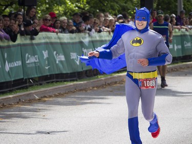 Hugo Breton dressed as Batman at the finish line of the marathon May 27, 2018 at Ottawa Race Weekend.    Ashley Fraser/Postmedia