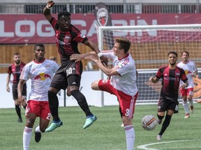 Ottawa Fury FC's Adonijah Reid (30) battles in the air for the ball against New York's Kevin Politz during USL regular season play at TD Place Stadium on Wednesday, May 2,2018.