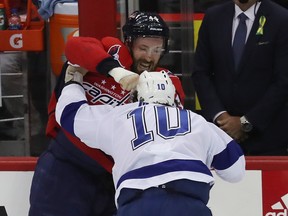 J.T. Miller of the Tampa Bay Lightning and Brooks Orpik of the Washington Capitals fight during Monday's game. (GETTY IMAGES)
