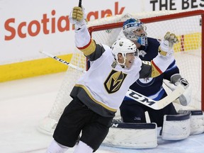 Tomas Nosek #92 of the Vegas Golden Knights celebrates a second period goal by Ryan Reaves #75 (not pictured) against the Winnipeg Jets in Game Five of the Western Conference Finals during the 2018 NHL Stanley Cup Playoffs at Bell MTS Place on May 20, 2018 in Winnipeg.