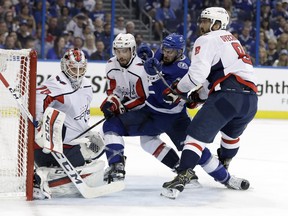 Tampa Bay Lightning center Cedric Paquette (13) tries to get past Washington Capitals left wing Alex Ovechkin (8), and defenseman Matt Niskanen (2) for a rebound on goaltender Braden Holtby during the second period of Game 5 of the NHL Eastern Conference finals hockey playoff series Saturday, May 19, 2018, in Tampa, Fla. (AP Photo/Chris O'Meara) ORG XMIT: TPA114