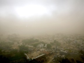 Village Itada is enveloped in thick blanket of dust during a dust storm in Noida near New Delhi, India, Sunday, May 13, 2018.