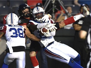 Montreal Alouettes' C.J. Moore (26) prevents Ottawa Redblacks' Seth Coate (75) from catching the ball in the endzone during first half of pre-season CFL action in Ottawa on Thursday, May 31, 2018.