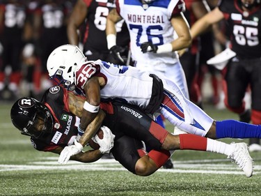 Ottawa Redblacks' RJ Harris (84) gets tackled by Montreal Alouettes' Tyquwan Glass (38) during second half CFL pre-season action in Ottawa on Thursday, May 31, 2018.