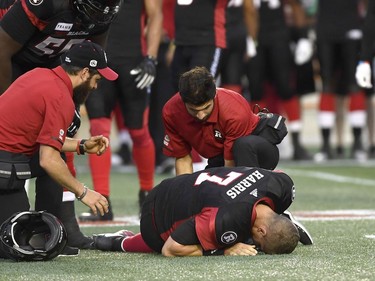 Ottawa Redblacks quarterback Trevor Harris (7) lies on the field after a collision, during pre-season CFL action against the Montreal Alouettes in Ottawa on Thursday, May 31, 2018.