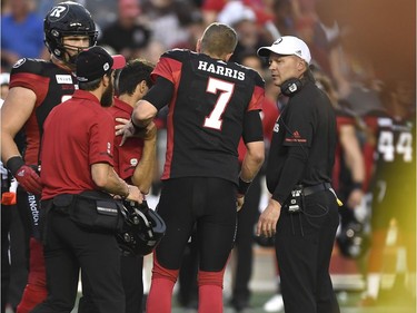 Ottawa Redblacks head coach Rick Campbell looks on as quarterback Trevor Harris (7) leaves the field after a collision, during pre-season CFL action against the Montreal Alouettes in Ottawa on Thursday, May 31, 2018.