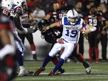 Montreal Alouettes quarterback Garrett Fugate (19) gets tacked by the Ottawa Redblacks during second half CFL pre-season action in Ottawa on Thursday, May 31, 2018.