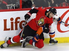 Winger Magnus Paajarvi checks Islanders centre Mathew Barzal during a game on March 27.