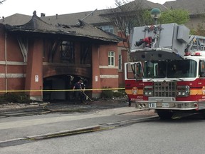 Fire crews clean up after a four-alarm blaze forced the evacuation of the Meridian seniors' home in Centrepointe early Sunday morning. No one was injured. AEDAN HELMER