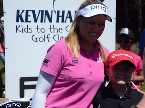 Brooke Henderson poses for a photo with a fan at Kids To the Course Classic held at Eagle Creek yesterday. Don Brennan/Ottawa Sun