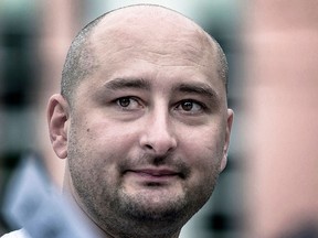In this photo taken on Friday, Aug. 9, 2013, Arkady Babchenko, who had been scathingly critical of the Kremlin in recent years, looks at an opposition picket in Moscow, Russia.