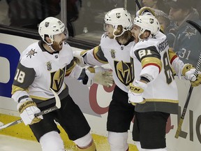 William Karlsson (centre), James Neal (left) and Jonathan Marchessault celebrate the winning goal against the San Jose Sharks during overtime of Game 3. (The Associated Press)