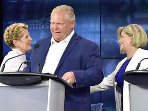 Ontario Liberal Leader Kathleen Wynne, left, shakes hands with Ontario NDP Leader Andrea Horwath, right, behind Ontario Progressive Conservative Leader Doug Ford following the end of the third and final televised debate of the provincial election campaign in Toronto, Sunday, May 27, 2018.