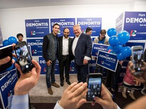 Mark DeMontis, middle, takes photos with Ontario Progressive Conservative leader Doug Ford during his campaign office opening for York South-Weston in Toronto on Saturday, May 12, 2018.