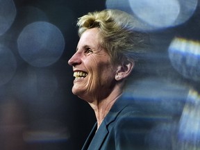 Ontario Liberal Leader Kathleen Wynne is pictured between glasses as she speaks during a campaign stop at Crosscut Distillery in Sudbury, Ont., on Wednesday, May 23, 2018.