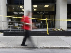 Police tape in front of 141c Laurier Ave in Ottawa Friday May 25, 2018. A woman was found bloodied and beaten inside the office at the Christian Science Reading Room at 141c Laurier Ave. West, Thursday.