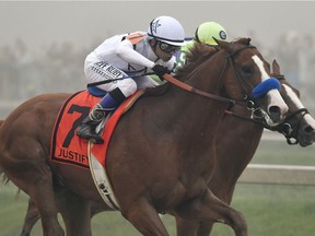 Justify with Mike Smith atop runs aganst Good Magic with Jose Ortiz atop in the final stretch of the 143rd Preakness Stakes horse race at Pimlico race track, Saturday, May 19, 2018, in Baltimore. Justify won the race.