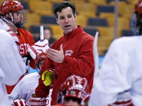 In this April 5, 2015, file photo, Boston University head coach David Quinn talks to his players during an NCAA hockey practice before the Frozen Four tournament in Boston