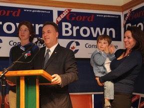 Leeds-Grenville-Thousand Islands and Rideau Lakes MP Gord Brown speaks to supporters surrounded by his sons, Chance, left, and Tristan and his wife, Claudine on Monday, Oct. 19, 2015 in Brockville, Ont.