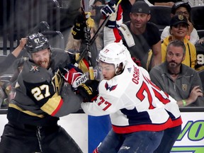 Shea Theodore of the Vegas Golden Knights (left) and T.J. Oshie of the Washington Capitals battle during Game 1 of the Stanley Cup final at T-Mobile Arena on Monday night. The two teams have been involved in eight of the 10 overtimes so far in these playoffs. (Photo by Bruce Bennett/Getty Images)