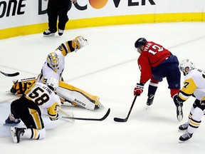 Washington Capitals left-wing Jakub Vrana, from the Czech Republic, scores the go-ahead goal past Pittsburgh Penguins goaltender Matt Murray and defenceman Kris Letang during the third period of Game 5 in the second round of the NHL Stanley Cup hockey playoffs, Saturday, May 5, 2018, in Washington. (AP Photo/Alex Brandon)