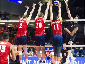Canada played USA in the  FIVB Volleyball Nations League Sunday June 10, 2018 at TD Place Arena. Canada's #7 Stephen Timothy Maar spikes the ball into the USA's L-R #2 Aaron Russell, #20 David Smith and #11 Micah Christenson.