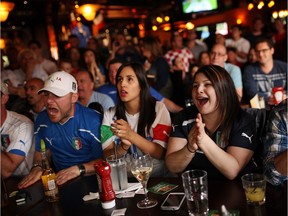 Fans watch the England v. Italy World Cup soccer match on Saturday, June 14, 2014 at Heart and Crown bar in Little Italy.