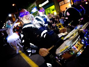 Members of Black Mohawk production group make their way down Bank Street during Glowfair Festival Friday June 17, 2016.