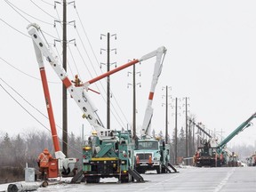 Hydro Ottawa crews repair power lines  that were damaged during the ice storm in Ottawa. on Limebank Road on April 17,2018.