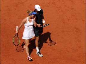 FILES: PARIS, FRANCE -   Gabriela Dabrowski of Canada and partner Mate Pavic of Croatia in conversation during the mixed doubles Final at the French Open on June 7, 2018 in Paris, France.