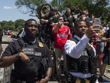 Members of the U.S. Secret Service stand watch as the Capitals parade down Constitution Avenue on Tuesday.