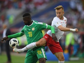 Mbaye Niang of Senegal is challenged by Jakub Blaszczykowski of Poland during the 2018 FIFA World Cup Russia Group H match at Moscow on Tuesday.