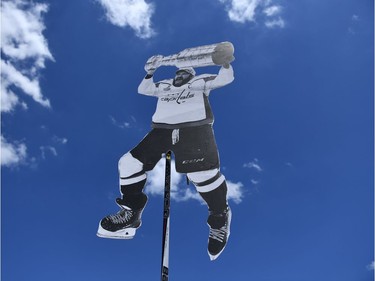 A poster of Capitals star Alex Ovechkin is raised to the sky during the Stanley Cup victory parade.